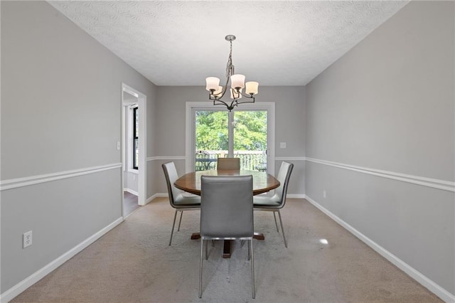 4811 Nevilly Way, Marietta, GA 30066 - carpeted dining area featuring baseboards, a notable chandelier, and a textured ceiling