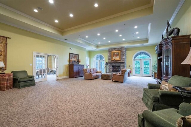 2304 Village Blvd, Rome, GA 30161 - carpeted living room featuring a raised ceiling, a stone fireplace, healthy amount of natural light, crown molding, and recessed lighting