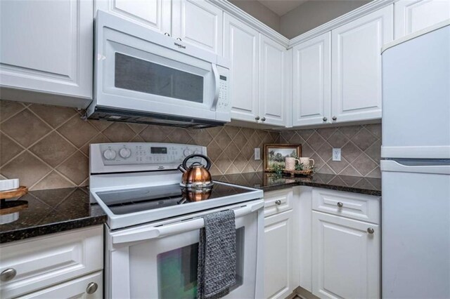 2304 Village Blvd, Rome, GA 30161 - kitchen with white appliances, white cabinetry, dark countertops, and backsplash