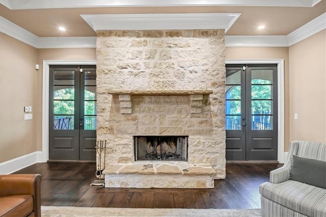 living room with a fireplace, plenty of natural light, crown molding, and dark wood-type flooring