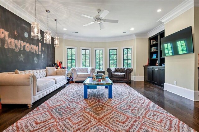 living room with dark wood-type flooring, a healthy amount of sunlight, and ornamental molding