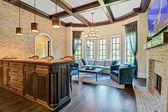 interior space with dark hardwood / wood-style flooring, a fireplace, and brick wall