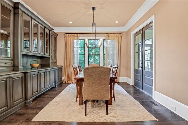 dining space featuring crown molding and dark hardwood / wood-style flooring