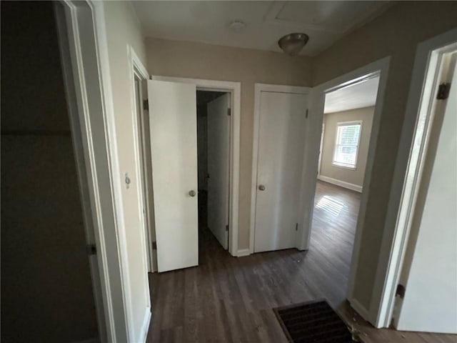 corridor with dark wood-type flooring