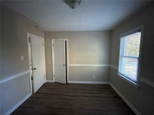 empty room with dark wood-type flooring