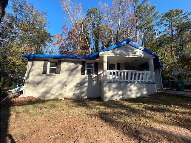 view of front of home with a front yard and a porch