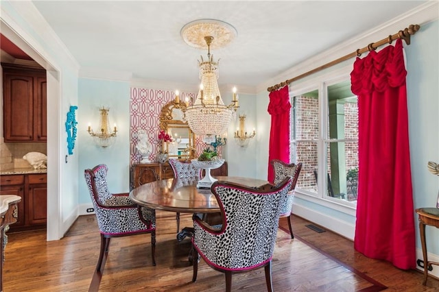 3215 Kylee Dawn Cir, Lawrenceville, GA 30045 - dining area with an inviting chandelier, baseboards, wood finished floors, and visible vents