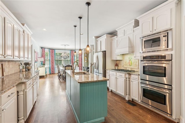 3215 Kylee Dawn Cir, Lawrenceville, GA 30045 - kitchen featuring appliances with stainless steel finishes, dark wood-style flooring, decorative backsplash, and a sink