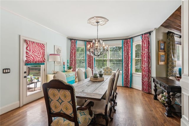 3215 Kylee Dawn Cir, Lawrenceville, GA 30045 - dining area with an inviting chandelier, wood finished floors, ornamental molding, and baseboards