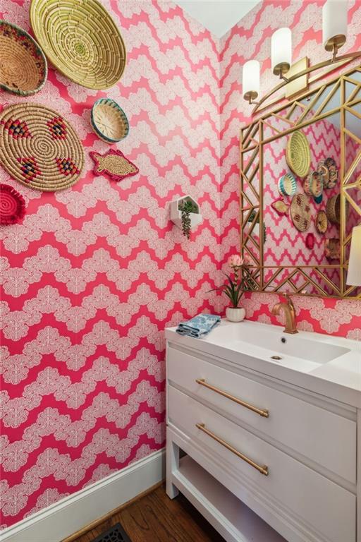 3215 Kylee Dawn Cir, Lawrenceville, GA 30045 - bathroom featuring wood finished floors, vanity, wallpapered walls, and baseboards