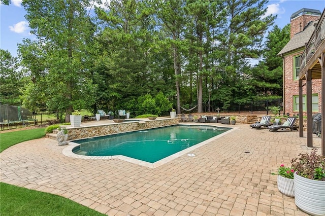 3215 Kylee Dawn Cir, Lawrenceville, GA 30045 - outdoor pool with a patio, a trampoline, and fence