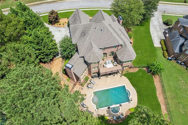 3215 Kylee Dawn Cir, Lawrenceville, GA 30045 - back of property featuring a lawn, a chimney, an in ground hot tub, and brick siding