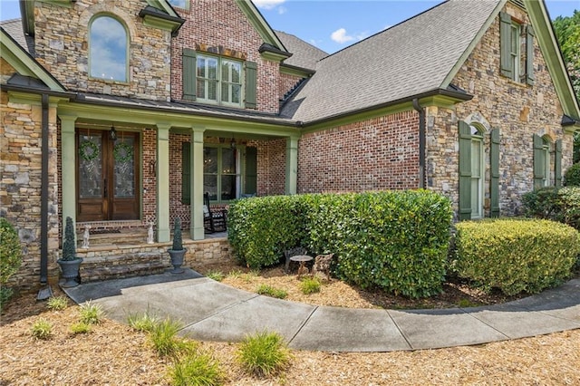 3215 Kylee Dawn Cir, Lawrenceville, GA 30045 - property entrance with a porch, a shingled roof, and brick siding
