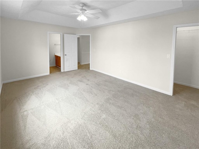 unfurnished bedroom featuring a spacious closet, baseboards, and a closet