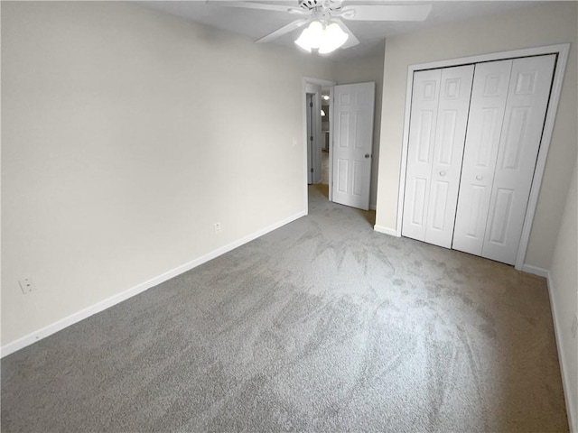 unfurnished bedroom featuring ceiling fan, baseboards, a closet, and light colored carpet