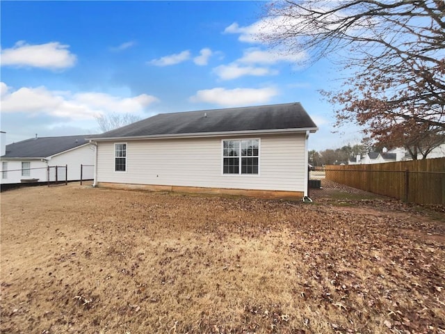 back of property featuring a fenced backyard