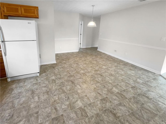 unfurnished dining area featuring baseboards