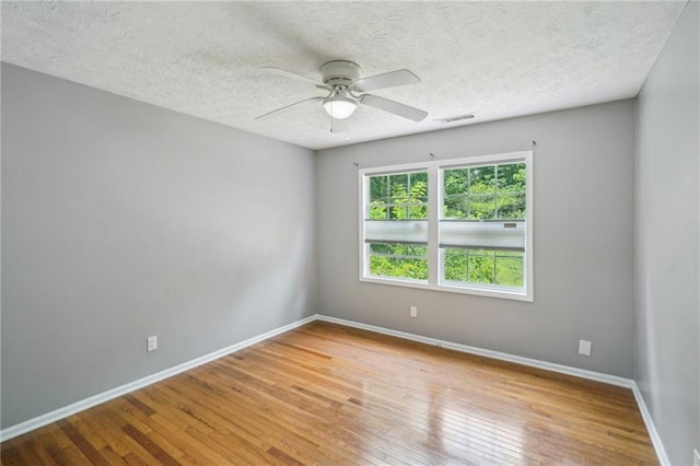 2201 Colonial Oak Way, Stone Mountain, GA 30087 - unfurnished room with hardwood / wood-style flooring, ceiling fan, baseboards, and a textured ceiling