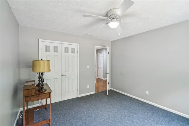 2201 Colonial Oak Way, Stone Mountain, GA 30087 - bedroom featuring a closet, carpet flooring, baseboards, a ceiling fan, and a textured ceiling