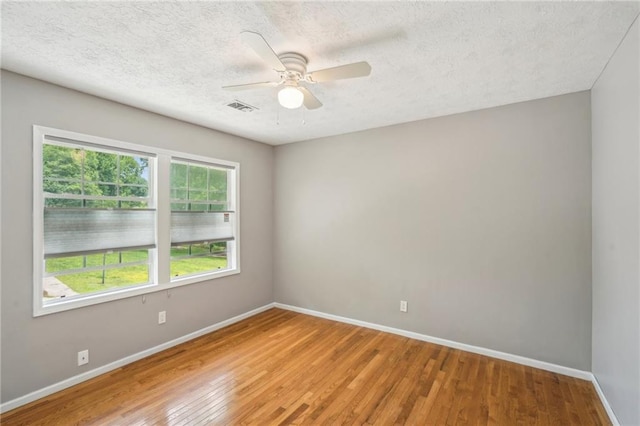2201 Colonial Oak Way, Stone Mountain, GA 30087 - unfurnished room featuring baseboards, light wood-style floors, a textured ceiling, and a ceiling fan