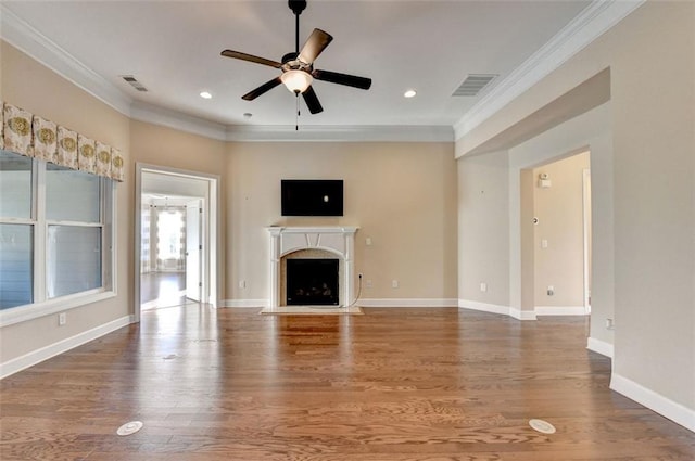 unfurnished living room with ceiling fan, wood-type flooring, and ornamental molding