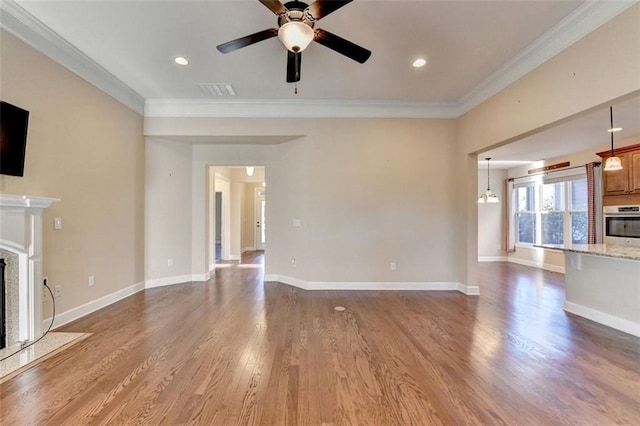 unfurnished living room with ceiling fan, crown molding, and wood-type flooring