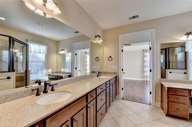 bathroom featuring a shower with door, tile patterned floors, and vanity