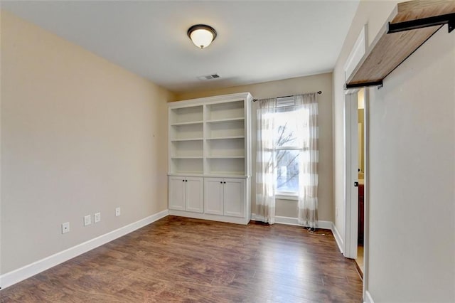 empty room featuring dark hardwood / wood-style flooring