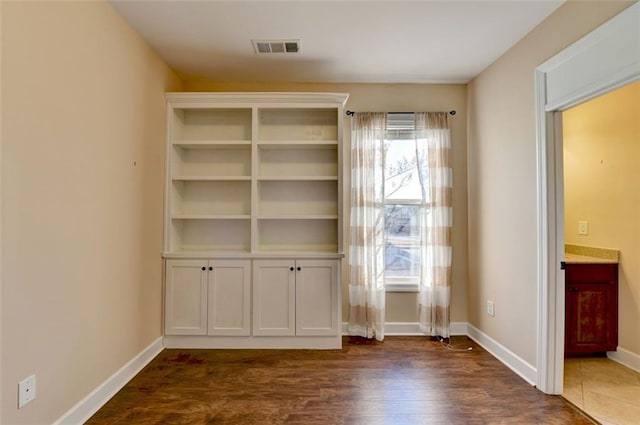 interior space with plenty of natural light and dark hardwood / wood-style flooring