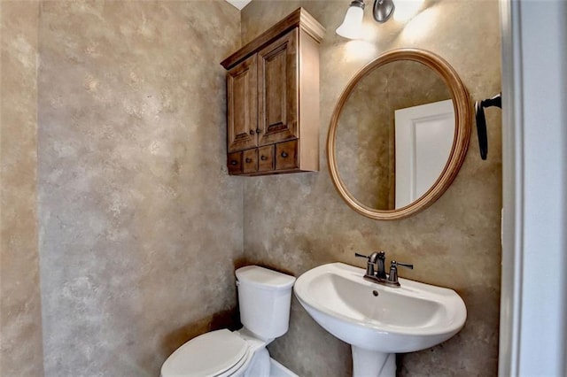 half bath with a sink and toilet