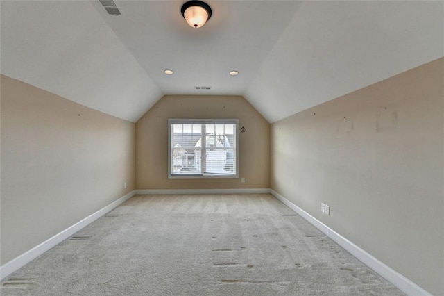 bonus room featuring lofted ceiling, carpet flooring, visible vents, and baseboards