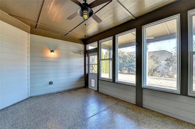 unfurnished sunroom featuring a ceiling fan