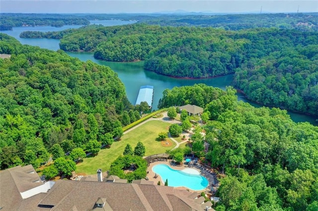 birds eye view of property with a water view and a wooded view