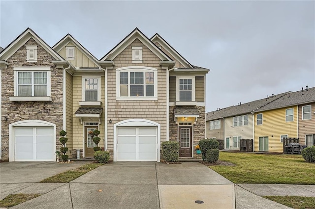 1963 Lakeshore Overlook Cir NW, Kennesaw, GA 30152 - townhome / multi-family property featuring a front yard, driveway, stone siding, and a garage