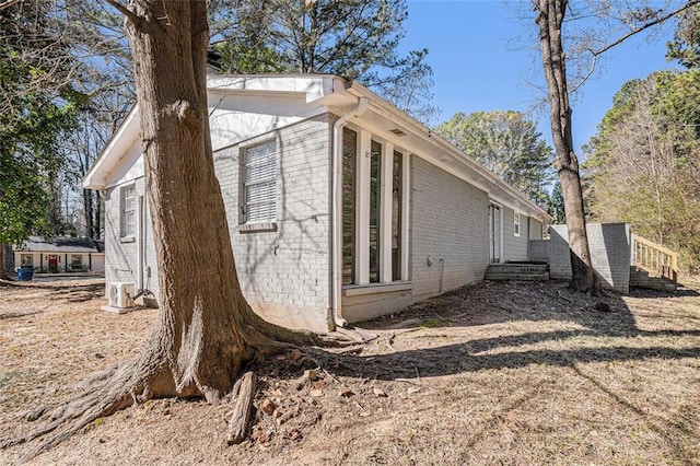 view of side of home featuring brick siding