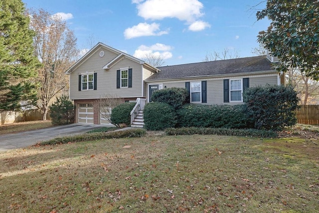 split level home featuring a garage and a front lawn