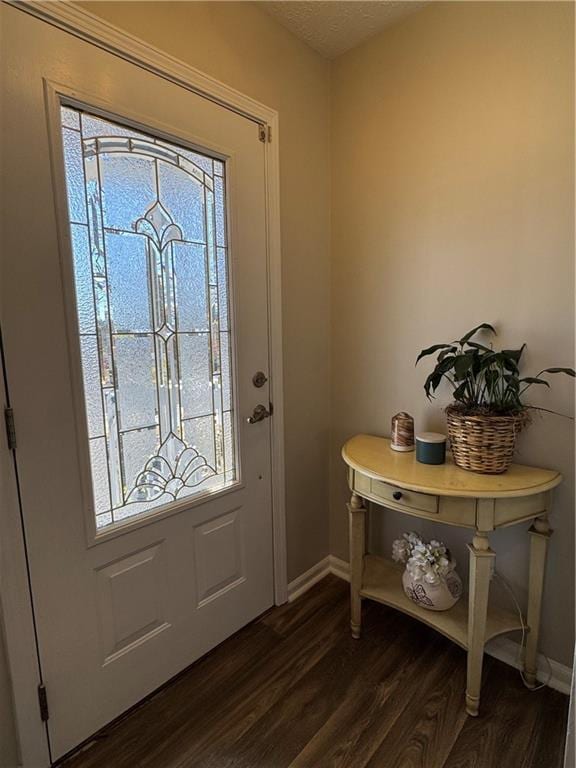 entryway featuring dark wood-style floors, a textured ceiling, and baseboards