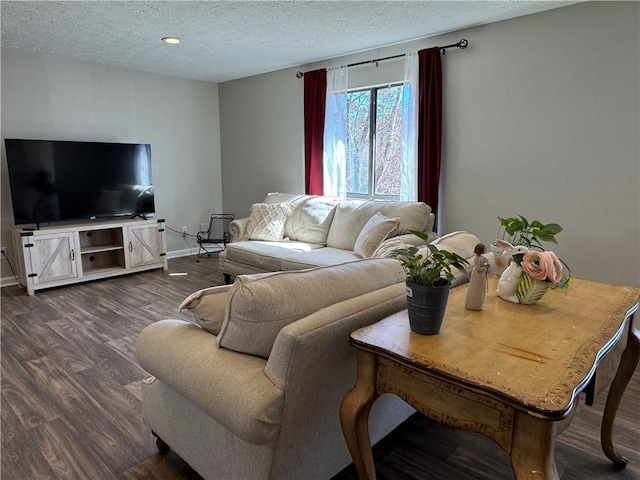 living room with recessed lighting, dark wood finished floors, a textured ceiling, and baseboards