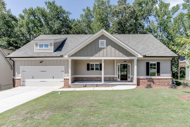 view of front of house with driveway, brick siding, board and batten siding, and a front lawn