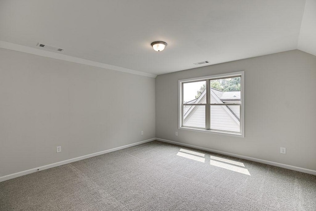 spare room with carpet, visible vents, and baseboards