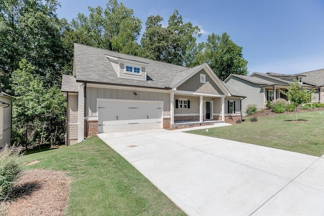 craftsman house with brick siding, concrete driveway, board and batten siding, a garage, and a front lawn