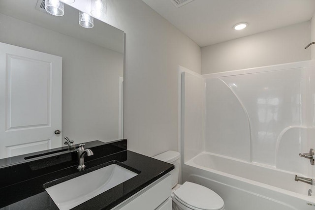 bathroom featuring toilet, shower / bathing tub combination, and vanity