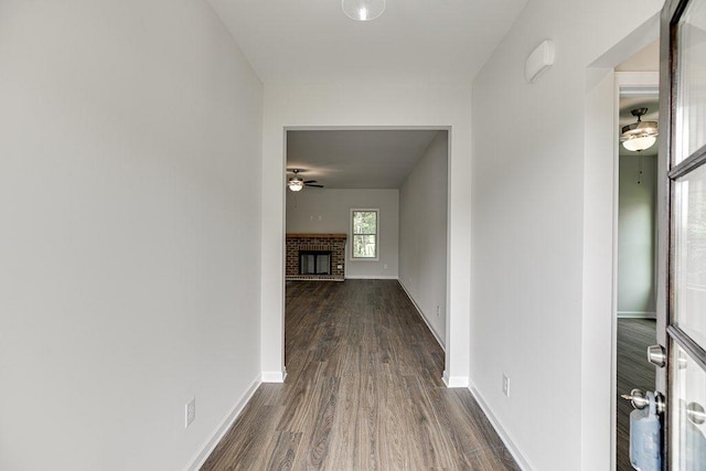 hall featuring dark wood-style floors and baseboards