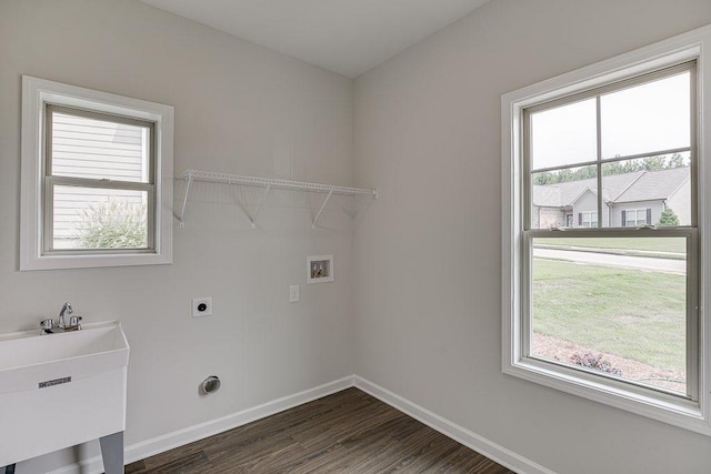 laundry area featuring hookup for a washing machine, laundry area, dark wood-style flooring, baseboards, and electric dryer hookup