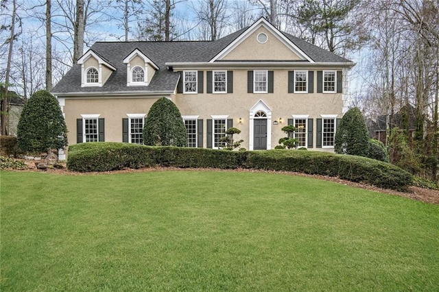 colonial-style house with a front yard