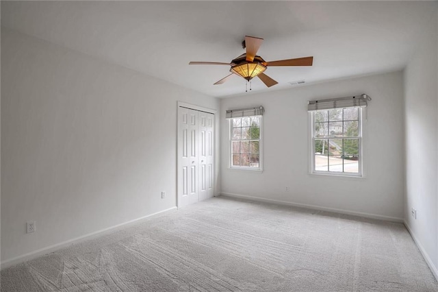 unfurnished room featuring light carpet and ceiling fan