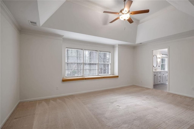 unfurnished room featuring light carpet, ornamental molding, ceiling fan, and lofted ceiling