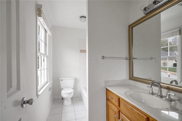 bathroom featuring vanity, toilet, tile patterned flooring, and a wealth of natural light