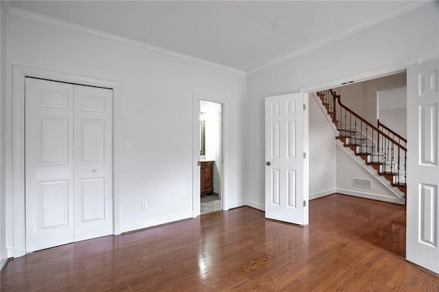 unfurnished room featuring dark wood-type flooring and crown molding