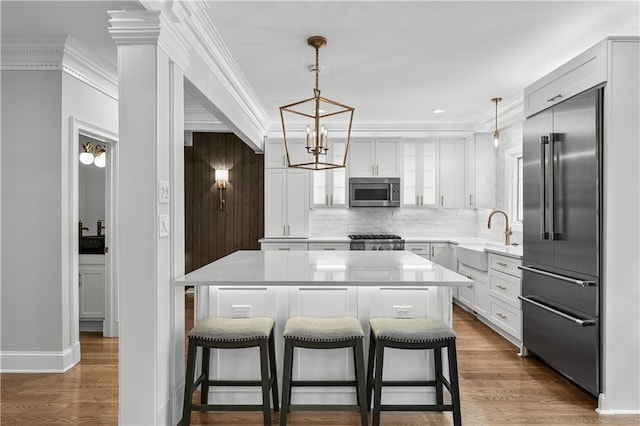 53 Paces W Dr NW, Atlanta, GA 30327 - kitchen featuring tasteful backsplash, a notable chandelier, a kitchen breakfast bar, appliances with stainless steel finishes, and a sink